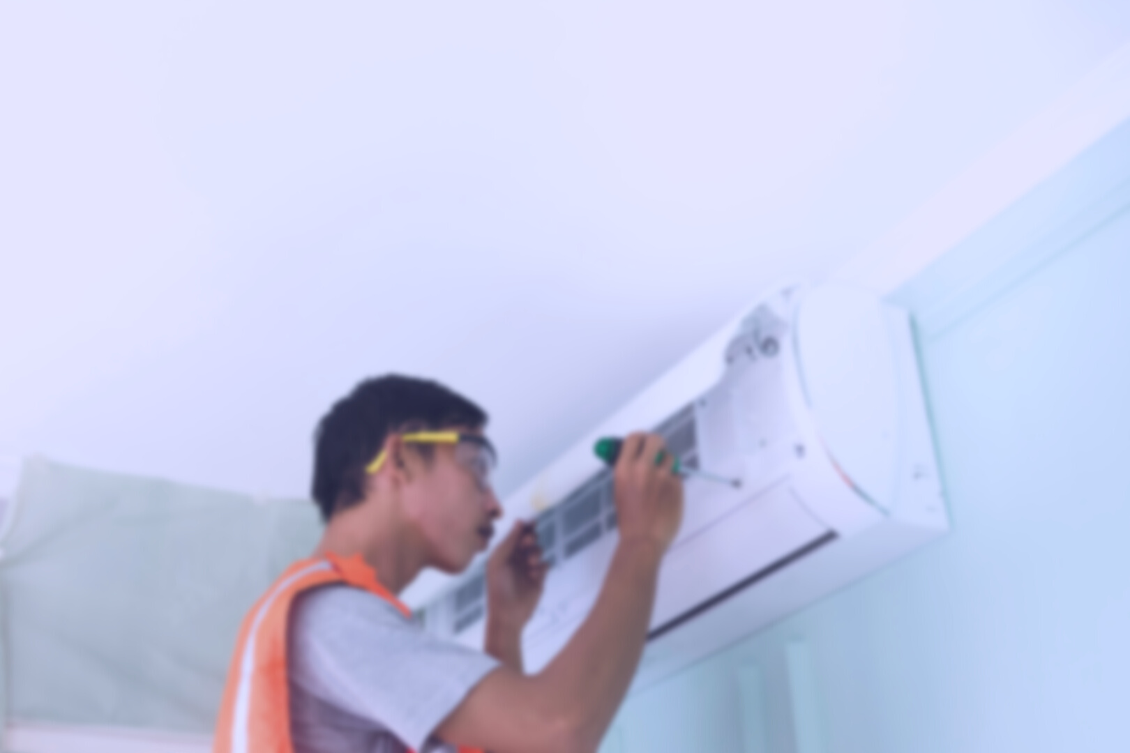 Man Repairing the Air Conditioning Unit